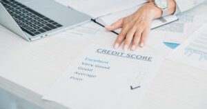 cropped view of woman showing credit score at office